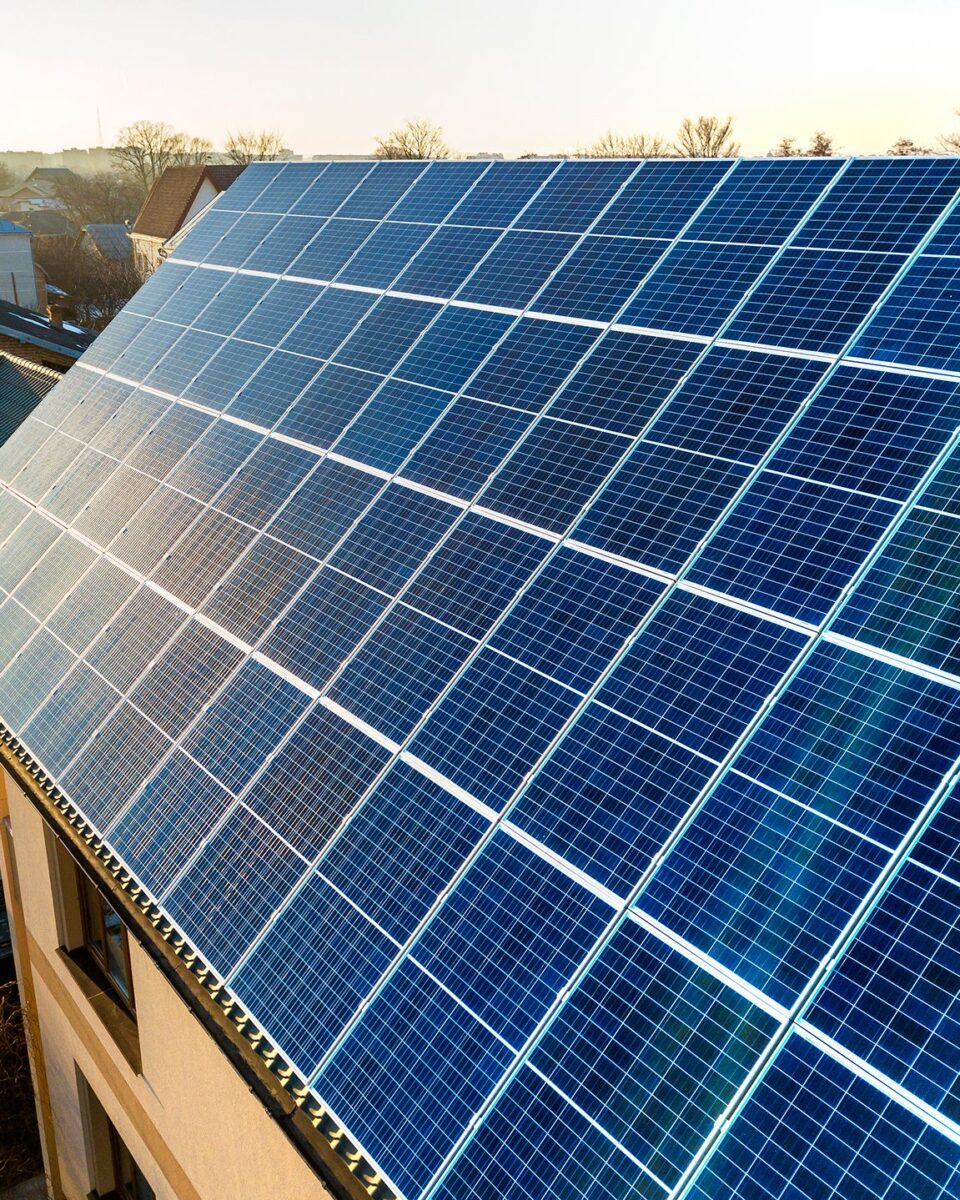 aerial-view-new-modern-two-story-house-cottage-with-blue-shiny-solar-photo-voltaic-panels-system-roof-renewable-ecological-green-energy-production-concept